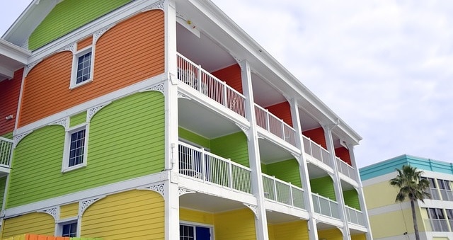 Building with balconies in different colors on each floor. Balcony painting ideas.