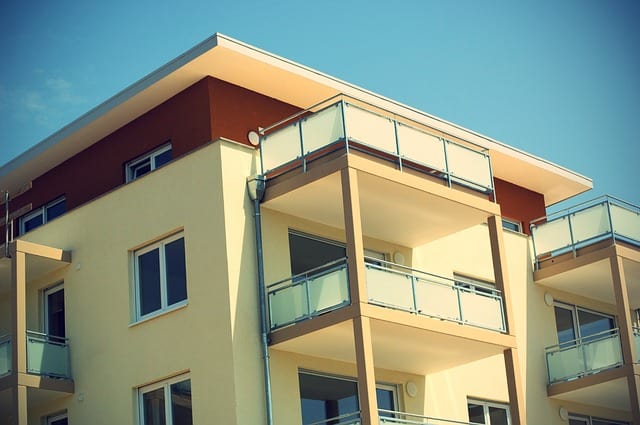 Image shows multistory house with balconies on each floor. Balconies on houses.