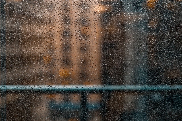 Rain on balcony window at high-rise building.