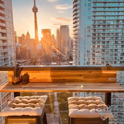 Balcony bar on high rise building with sunset in background.