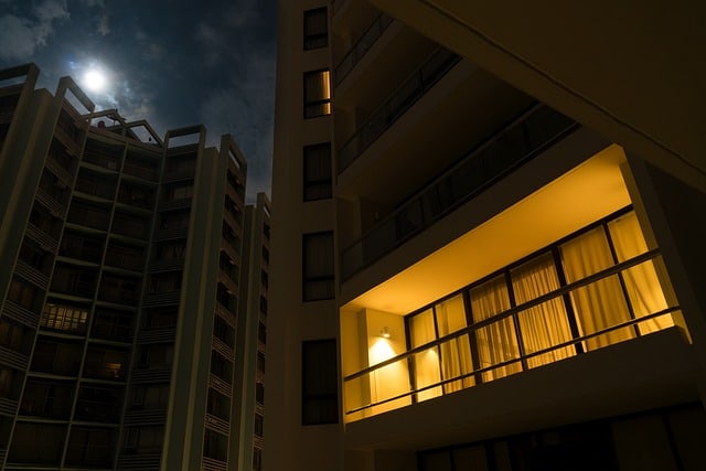Balcony illuminated by outdoor lamp at night. 